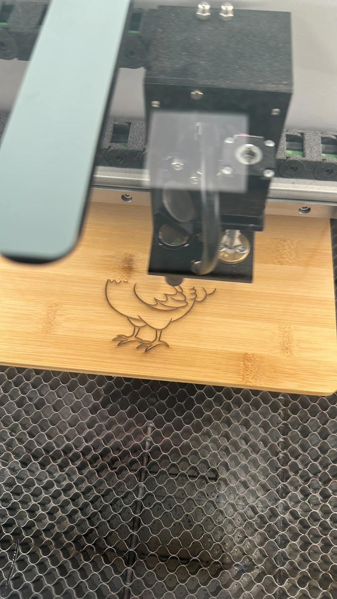 Laser engraving of a motif on a wooden board